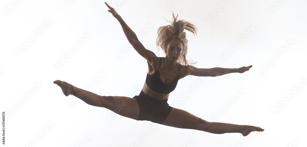 female sporty ballet dancer in front of white background female sporty ballet dancer in front of white background