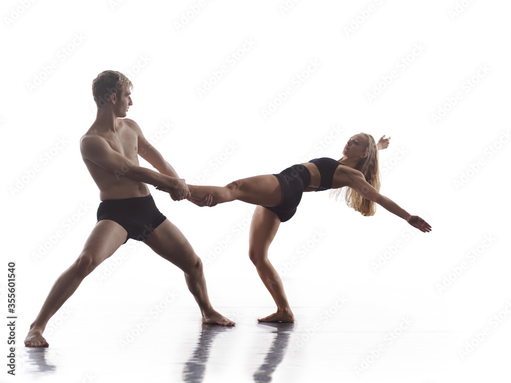 couple of athletic dance partners in front of white background