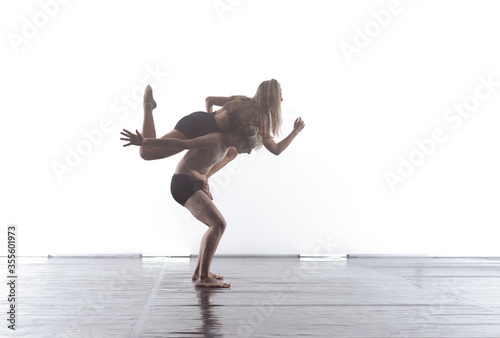 couple of athletic dance partners in front of white background