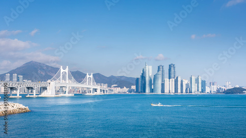 busan city and Gwangan bridge and fisherman's boats, Haeundae, Busan,Korea. photo