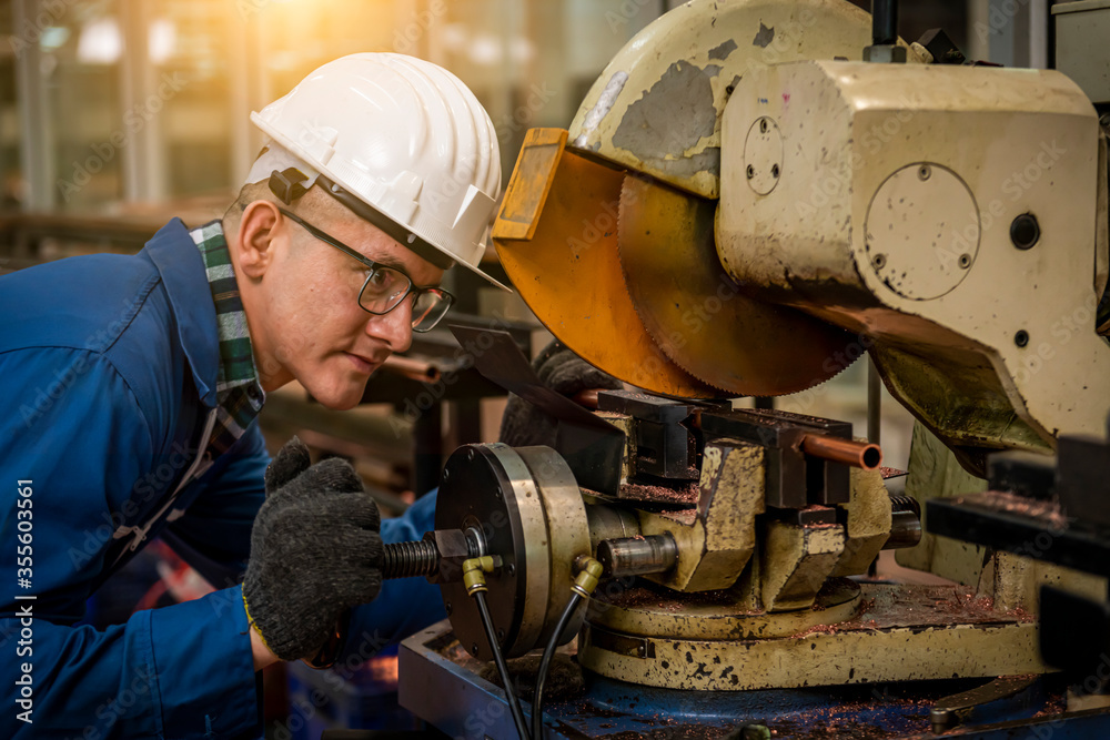 The Industry engineering wearing safety uniform control operating lathe grinding machine working in industry factory. The Industry engineering wearing safety uniform control operating lathe grinding machine working in industry factory.
