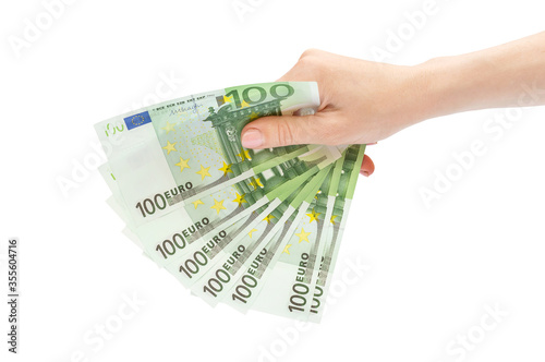 Woman's hand holding one hundred euro banknotes. Isolated on white.