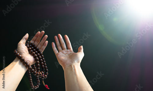 Rosary beads on a man's hand, the islamic conocept .