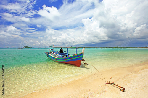 Colorful boats and sandy beaches in Belitung, Indonesia.