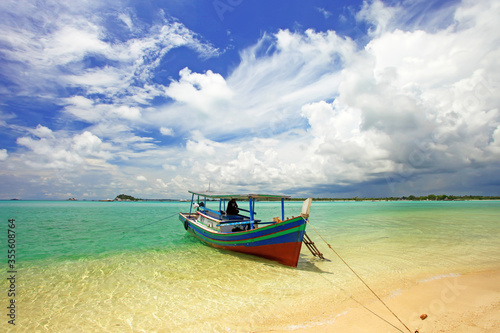 Colorful boats and sandy beaches in Belitung, Indonesia. © LilyRosePhotos