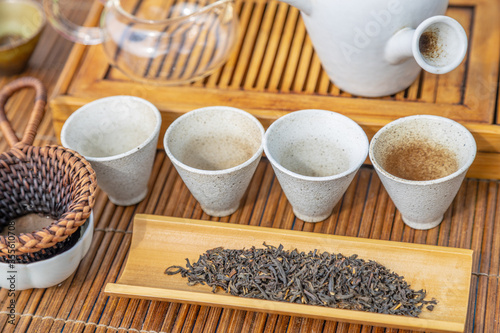 Tea ceremony at the outdoors camping site. Still life of appliances for tea consumption laid down on the tea table with tea and incense sticks.