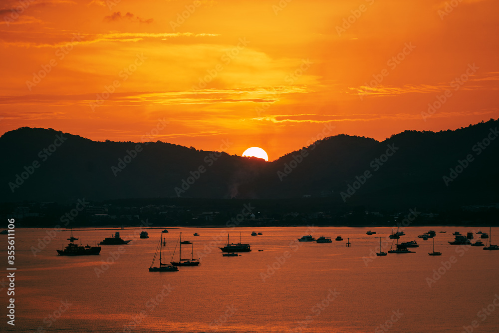 Beautiful landscape. Colorful sunset on the sea lagoon with yachts.