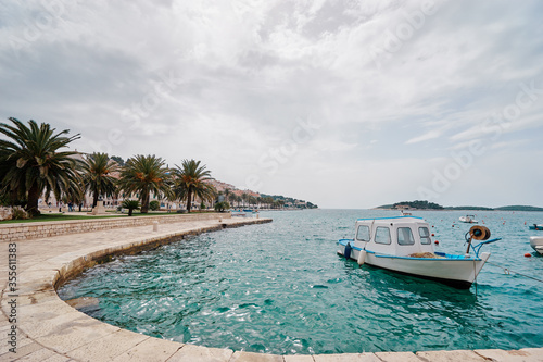 Fishing boats in harbor. Hvar Old Town Promenade. Sea coast in Dalmatia, Croatia.