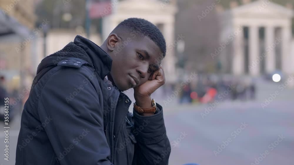 young thougthful black man alone in the city young thougthful black man alone in the city