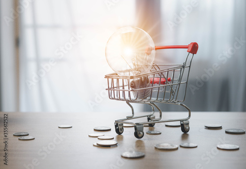 Photos Concepts and products in field of e-commerce and marketing, business, shopping The growth of the economy That constantly grows As if with a bright glowing light all the time, The light bulb in cart