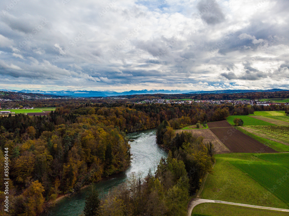 stormy autumn day over the river Reuss with a view of the alps