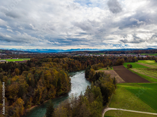 stormy autumn day over the river Reuss with a view of the alps