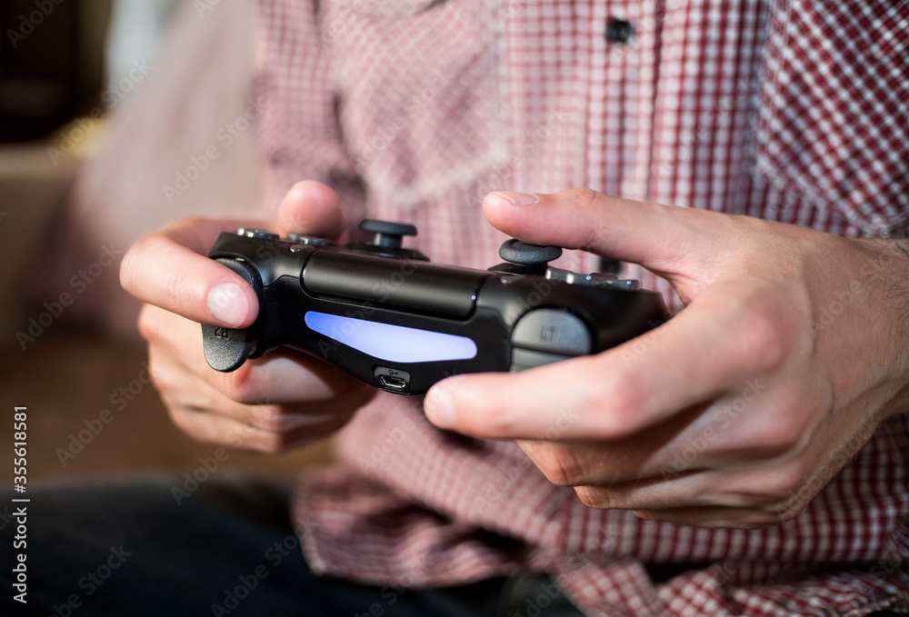 Man plays with gamepad in hands