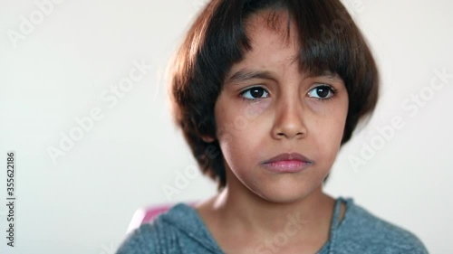Sad tearful young boy. Upset mixed reace ethnically diverse child photo