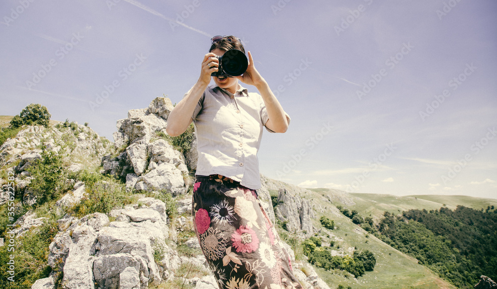 happy female photographer on a mountain