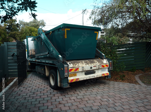 Skip hired being delivered on a truck photo