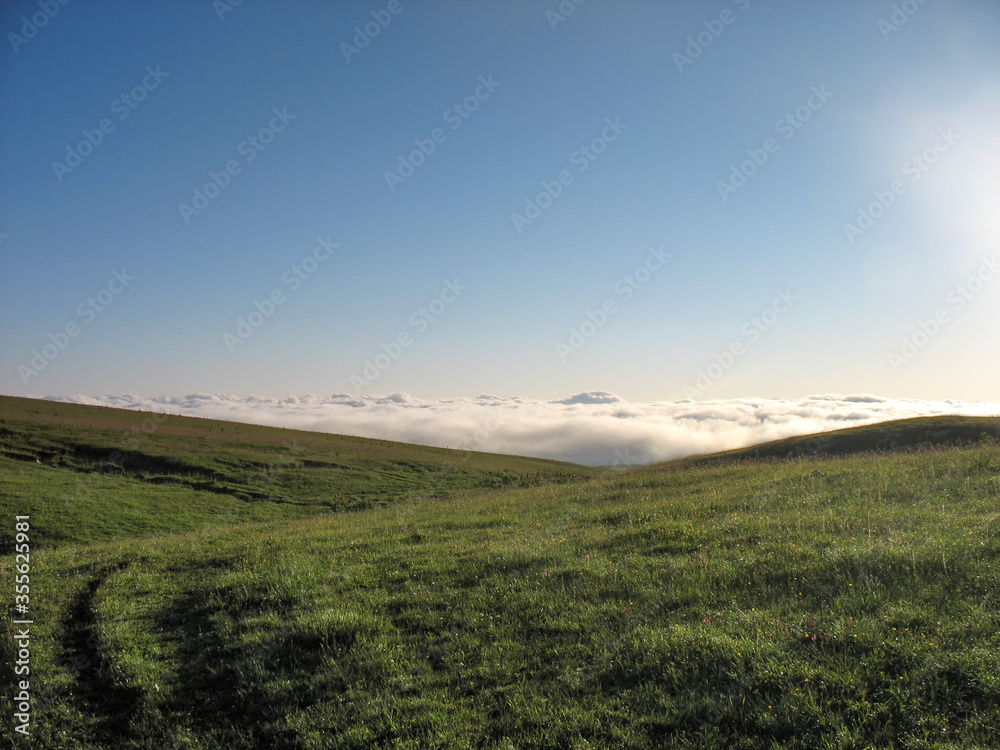 Green meadow above the clouds