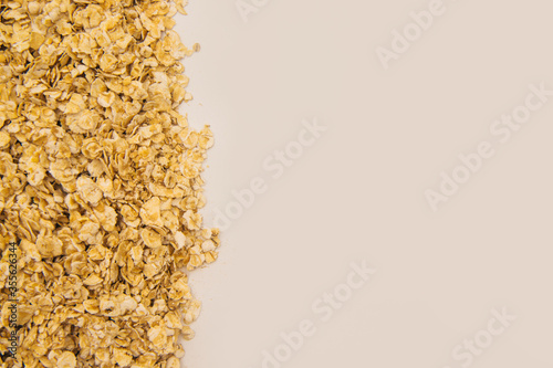 Oatmeal flakes scattered on a white background. Dietary food. Healthy breakfast.Texture and background.