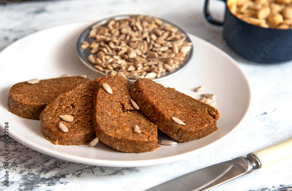 Homemade sunflower halva sliced on a white plate Homemade sunflower halva sliced on a white plate