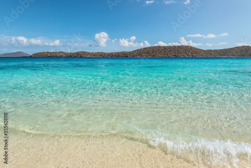 Coki Point Beach and Thatch Cay island in the background in St Thomas, USVI, Caribbean. Summer Vacation Travel Concept.