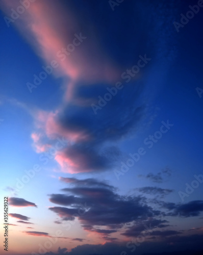 colorful clouds in the blue sky refelecting the light of sun photo