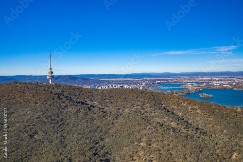 Aerial panoramic view looking past Telstra Tower toward Lake Burley Griffin in Canberra, the Capital of Australia on a sunny day  photo