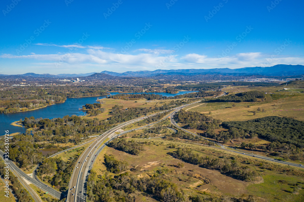 Aerial panoramic view looking over Glenloch Interchange and Lake Burley Griffin on a sunny day 
