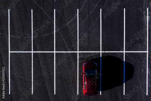 Aerial view of one car on a parking square