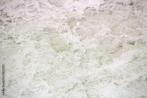white foam of a wave at leblon beach in Rio de Janeiro.