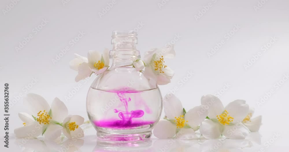 Oil Essence Flower Organic Product. Perfumery. Drops of aroma floral liquids falling from cosmetic pipette to glass bottle with perfume. Skin and body care. Beauty in nature, Beautiful jasmine Oil Essence Flower Organic Product. Perfumery. Drops of aroma floral liquids falling from cosmetic pipette to glass bottle with perfume. Skin and body care. Beauty in nature, Beautiful jasmine