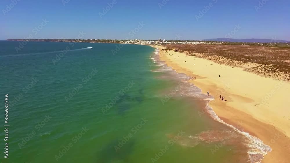 Drone flight over empty Gale beach in Portugal with top view on shoreline Drone flight over empty Gale beach in Portugal with top view on shoreline