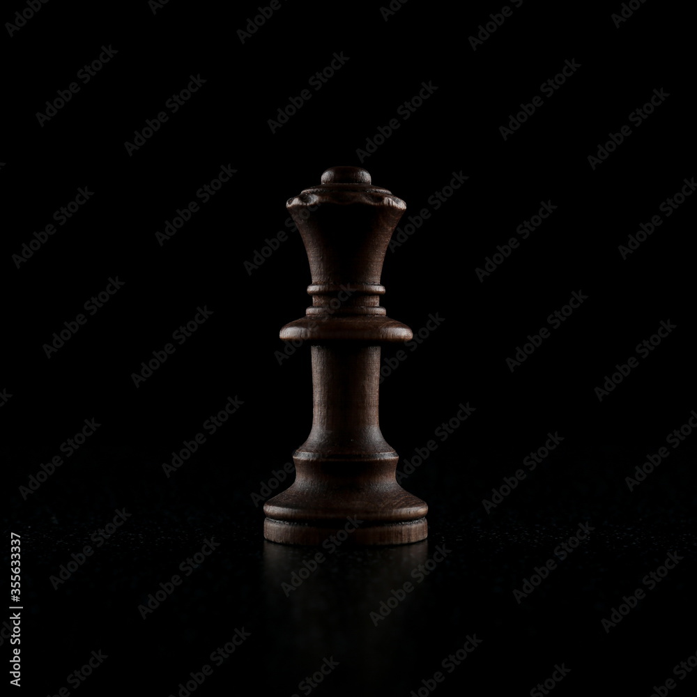 black chess piece on a black background black chess piece on a black background