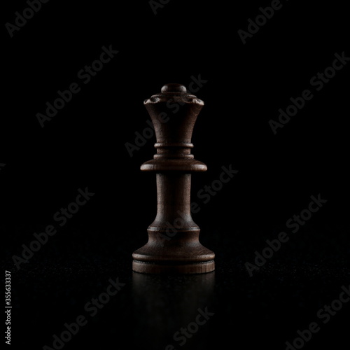 black chess piece on a black background