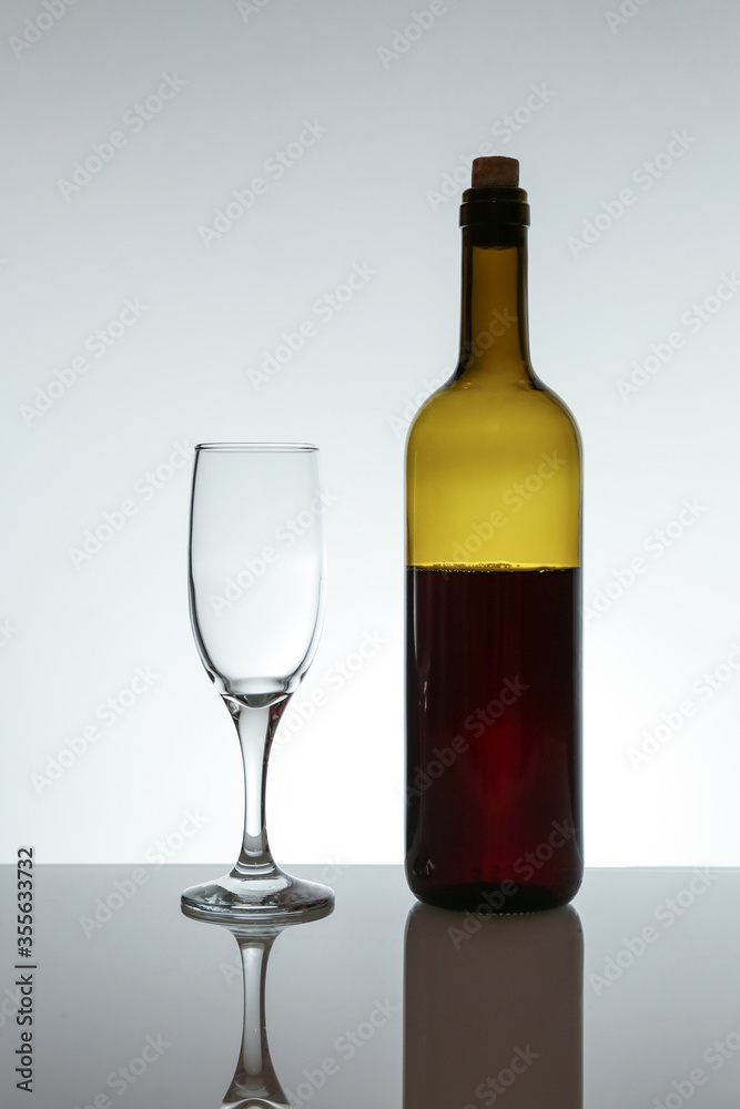 red wine bottle and wineglass on white background red wine bottle and wineglass on white background
