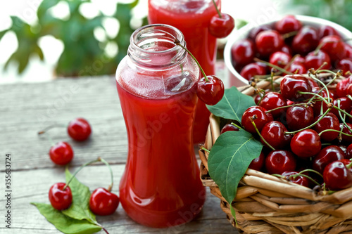 ripe cherries in a basket and fruit juice