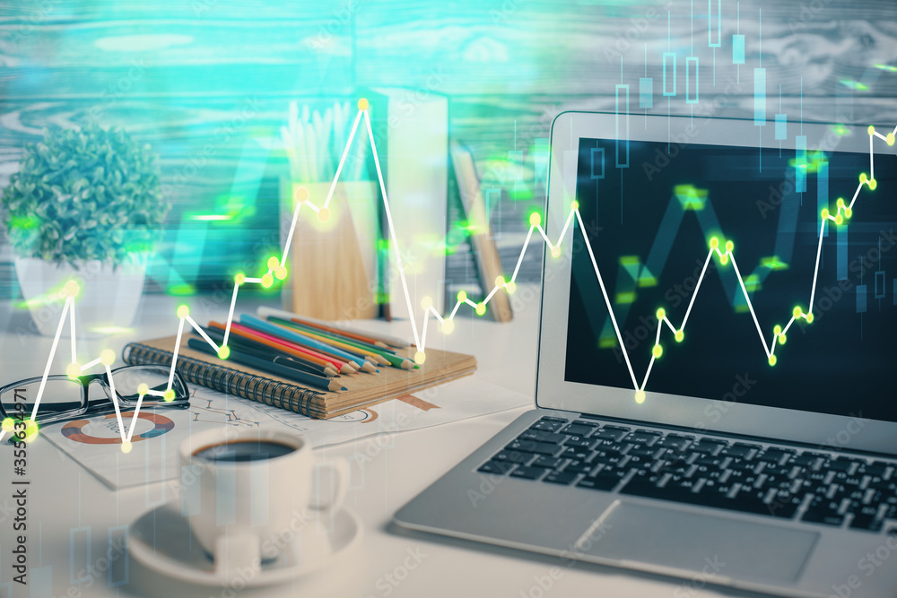 Forex market chart hologram and personal computer background. Multi exposure. Concept of investment.