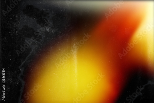 Orange light on black background. Imitation old analog photo effect. 