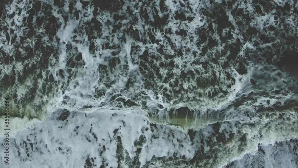 Bubbling waves of sea surf view from above