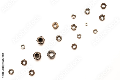 Metal nuts on a white background at the bottom. Background for car, bicycle, and scooter repair shops. Сopy space.