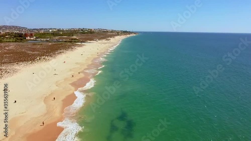 Drone flight over empty Gale beach in Portugal with top view on shoreline