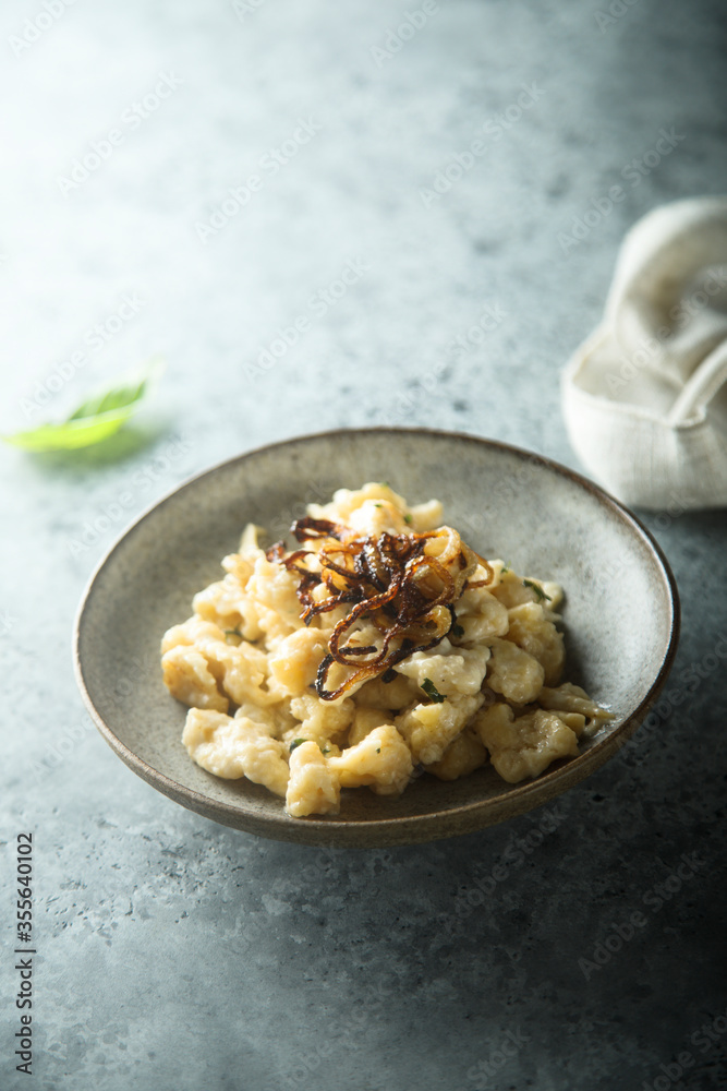 Traditional German noodles with cheese and fried onion