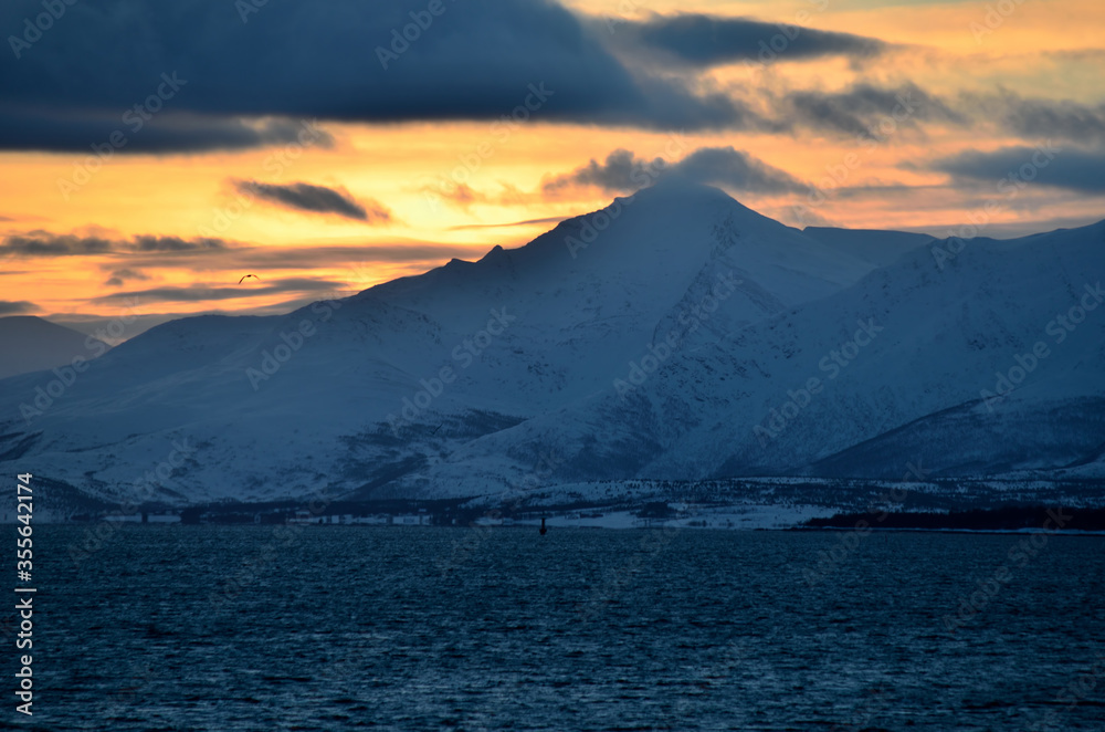 colorful dawn sky over snowy mountain and sea colorful dawn sky over snowy mountain and sea