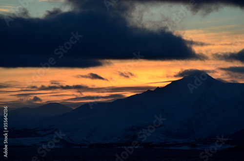 colorful dawn sky over snowy mountain and sea © Arcticphotoworks