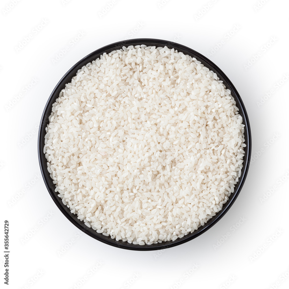 Uncooked round rice in black bowl isolated on white background with clipping path Uncooked round rice in black bowl isolated on white background with clipping path