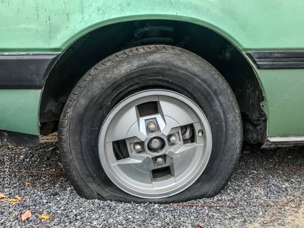 Flat Tire of a old green car