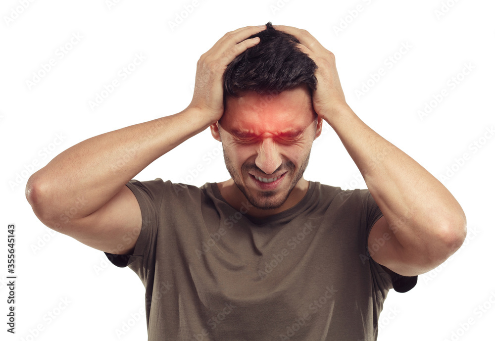 Upset unhappy young man squeezing head with hands, suffering from headache. People, stress and migraine concept Upset unhappy young man squeezing head with hands, suffering from headache. People, stress and migraine concept