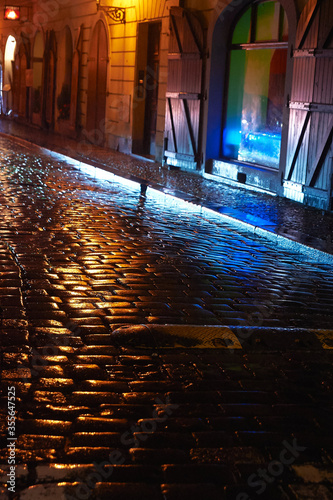 Climate street with cobblestones in the old part of the city of Prague in the evening