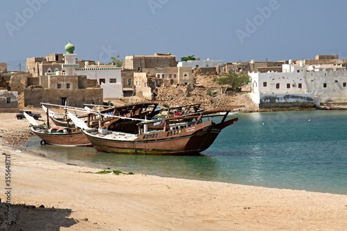 Fototapeta Naklejka Na Ścianę i Meble -  View of Mirbat town, moored boats and Arabian sea. Oman. Asia.
