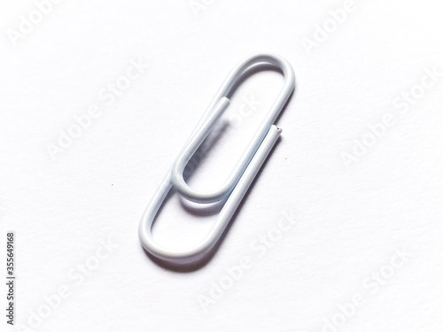 White paper clip on white background