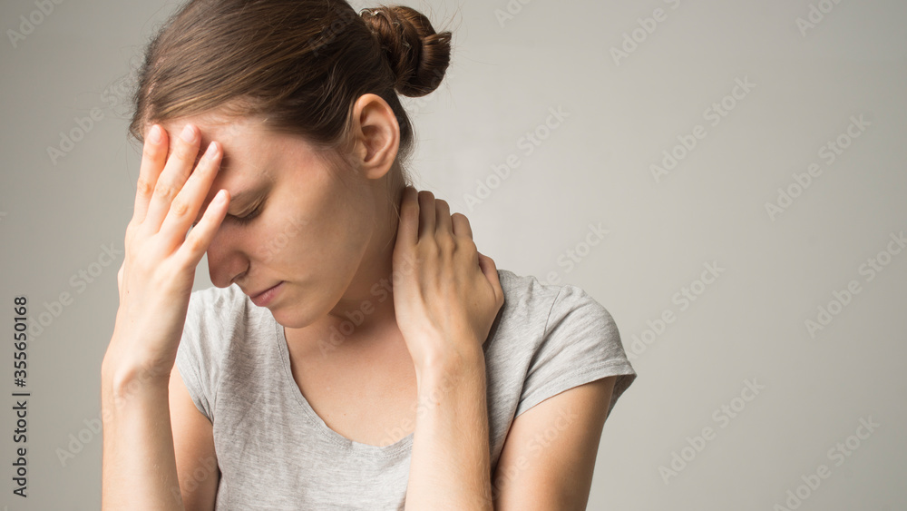 Fototapeta premium Headache And Stress. Beautiful Young Woman Feeling Strong Head Pain. Portrait Of Tired Stressed Female Suffering From Painful Migraine, Holding Hands Near Face. Health Care Concept. High Resolution